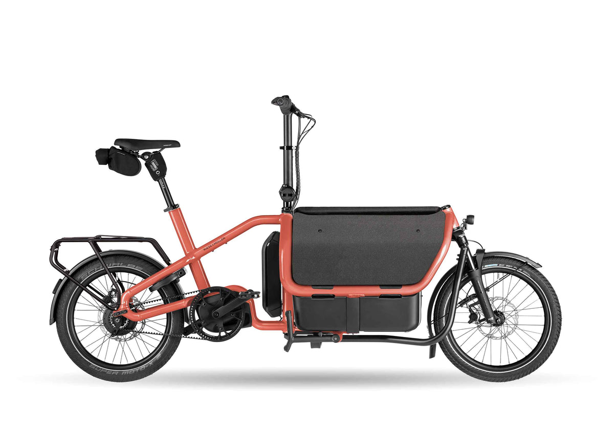 Riese & Müller Carrie2 Vario compact cargo e-bike in Coral, studio photo showing the front cargo box and step-through frame
