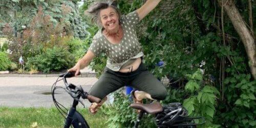 Customer celebrating electric bike purchase at Scooteretti Ottawa store