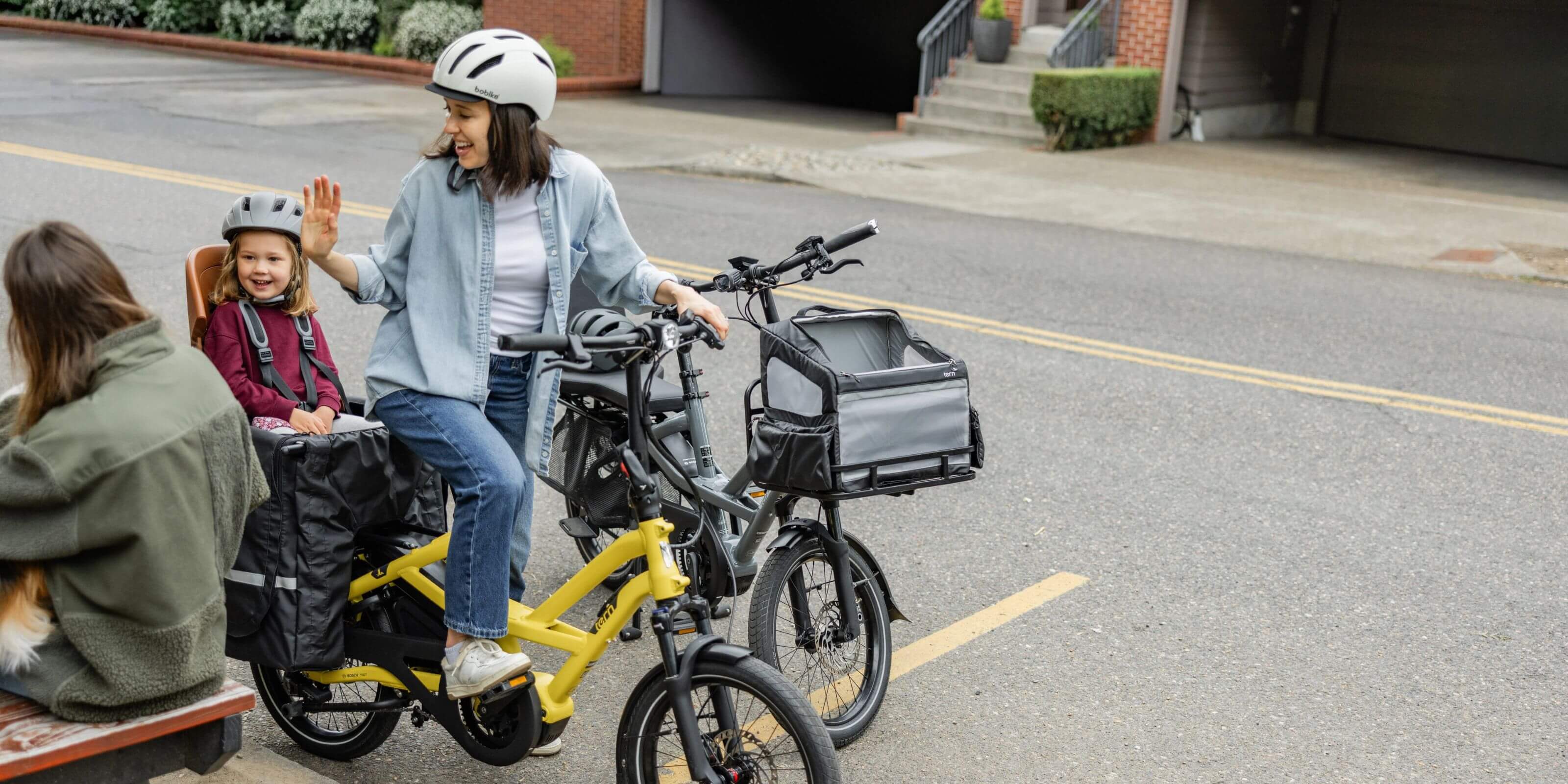 Two families riding Tern HSD P5i cargo e-bikes