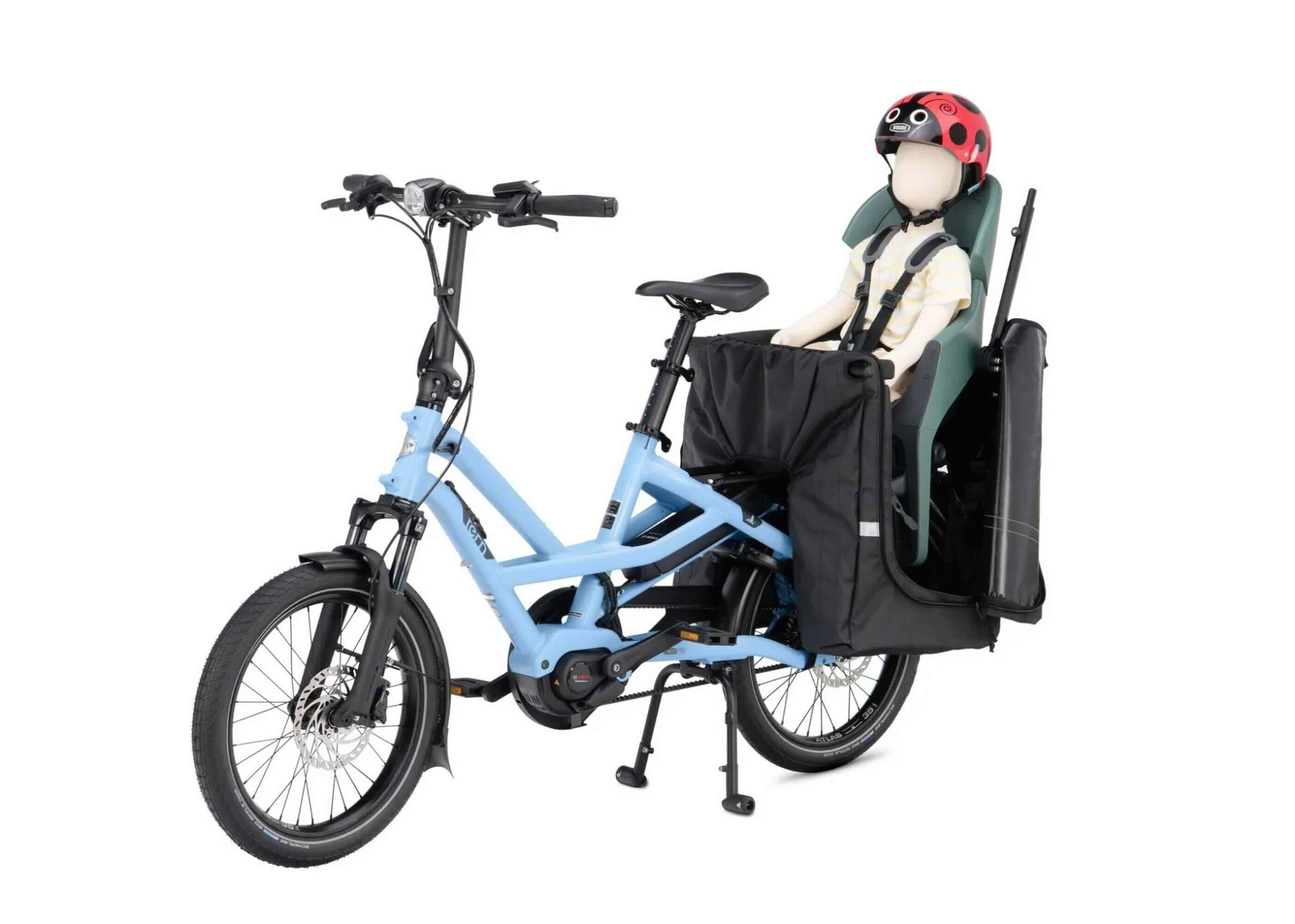 Tern Storm Box Mini (Gen 2) with its zip-open side panel unzipped, showing a child seat installed inside the bucket